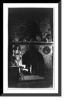 Historic Framed Print, [Helena Modjeska, full-length portrait, standing, facing right, pouring from tea kettle in front of fireplace],  17-7/8" x 21-7/8"