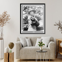 Historic Framed Print, [Mrs. Calvin Coolidge, half-length portrait, standing, facing front, holding her pet raccoon],  17-7/8" x 21-7/8"
