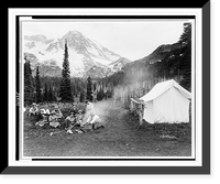 Camping party of men and women cooking at campfire and eating near tent in Indian Henry, Mt. Rainier National Park, Washington.Curtis & Miller. Classic, Historic Print