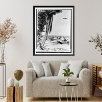 Beach scene with palm trees in foreground and Goodyear blimp above.photo by G.W. Romer, Miami, Fla, Vintage Print