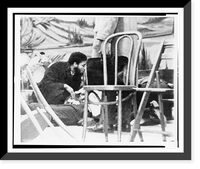 Historic Framed Print, Followers of Malcolm X try to comfort firey renegade of the negro radical movement, as he lies mortally wounded on stage in an upper Manhattan ballroom Feb. 21, after he was cut down by bullets,  17-7/8" x 21-7/8"