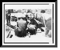 Historic Framed Print, Followers of Malcolm X try to comfort firey renegade of the negro radical movement, as he lies mortally wounded on stage in an upper Manhattan ballroom Feb. 21, after he was cut down by bullets - 2,  17-7/8" x 21-7/8"