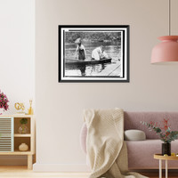 Historic Framed Print, [Three Girl Scouts in boat at a camp],  17-7/8" x 21-7/8"