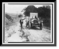 Historic Framed Print, [Man standing in rut, with hand on automobile],  17-7/8" x 21-7/8"