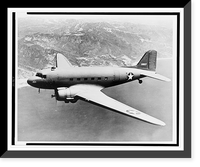 Douglas C-47, a military airplane, in flight over large body of water, with mountains in background, Antique Wall Art