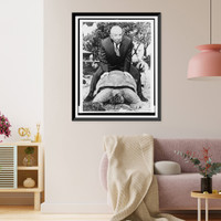 Alfred Hitchcock rides astride a turtle during a visit to the zoo in Sydney, Australia, Historic Print