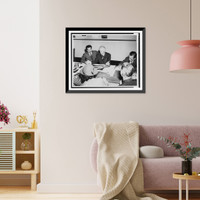 Historic Framed Print, [Frank Lloyd Wright, seated at a table with Roy S. Thurman; drawings for Crystal Heights in Washington, D.C., are on the table; reporters [?] take notes].Harris & Ewing.,  17-7/8" x 21-7/8"