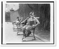 Unidentified boy, seated on park bench, probably in Washington, D.C., holding book, Historic Print