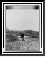 Historic Framed Print, [Pima woman, with burden basket on back, walking away from camera, Pima, Arizona],  17-7/8" x 21-7/8"