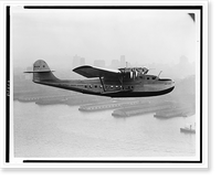 Historic Framed Print, [Aerial view of Pan American Airways China Clipper" - San Francisco piers and skyline in silhouette].Clyde H. Sunderland,  commercial and aerial photographs,  Oakland,  California.",  17-7/8" x 21-7/8"