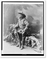 Buffalo Bill Cody, full-length portrait, seated, facing left, holding rifle, Vintage Print
