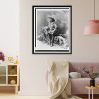 Buffalo Bill Cody, full-length portrait, seated, facing left, holding rifle, Vintage Print