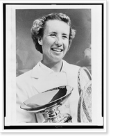 Maureen Connolly, head-and-shoulders portrait, facing slightly right, holding championship cup and two tennis rackets, Antique Print