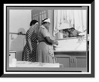 San Augustine, Texas. Mrs. Thomas, the wife of a wholesale grocer, in her kitchen with her maid, Vintage Wall Art