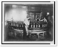 Historic Framed Print, [Boys pouring wax(?) into molds in factory],  17-7/8" x 21-7/8"