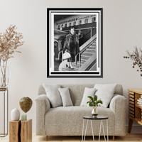 Christine Jorgensen, full-length portrait, facing front, waving as she boards an airplane, at Copenhagen, Denmark, Historic Print