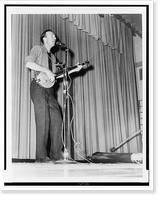 Pete Seeger, full-length portrait, performing on stage at Yorktown Heights High School, Yorktown, N.Y..World Journal Tribune photo by James Kavallines, Vintage Print