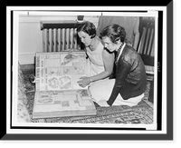 Gertrude Ederle and another woman sitting on floor looking at scrapbook of newspaper clippings of Ederle's swimming feats, Antique Poster