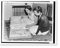 Gertrude Ederle and another woman sitting on floor looking at scrapbook of newspaper clippings of Ederle's swimming feats, Antique Poster