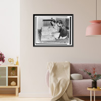 Gertrude Ederle and another woman sitting on floor looking at scrapbook of newspaper clippings of Ederle's swimming feats, Antique Poster