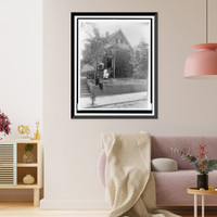 African American man seated on stone wall and two girls on lawn in front of house in Georgia, Antique Print