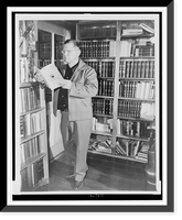 Erle Stanley Gardner, full-length portrait, standing, looking at a book in his library, near Temecula, California, Antique Wall Art