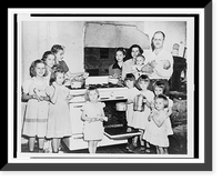 Mr. and Mrs. Lloyd Brooks of Pittsfield, Maine, and their twelve daughters posed around stove in kitchen, Vintage Print