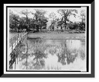 Body of water with reeds, wooden bridge, and boat in foreground, and house in background, Brownsville, Northampton Co., Virginia, Historic Reproduction
