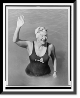 Florence Chadwick, half-length, right hand raised, emerges from the water after her fourth swim of the English Channel, Antique Print