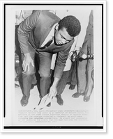 Muhammad Ali, formerly Cassius Clay, stooping to pick up envelope at entrance to the Armed Forces examining and entrance station in Houston, Texas, Antique Wall Art