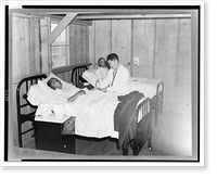 Historic Framed Print, Manzanar, Calif., 1942. Dr. James Coto, Los Angeles physician and surgeon, examining an elderly patient in the emergency hospital at the War relocation authority center for evacuees of Japanese ancestry,  17-7/8" x 21-7/8"