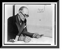 Le Corbusier, half-length portrait, seated at desk, facing right, working on drawing, Antique Wall Art