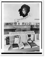 Exhibit of chiefly anti-communist and anti-Jewish propaganda, with books on table and shelves, The Hague, Netherlands, Antique Print