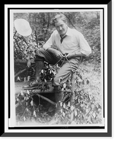 John Charles Thomas, singer, full-length portrait, sitting on log bench, whittling a small branch Classic, Vintage Wall Art