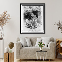 San Ildefonso Pueblo man Julian Martinez, seated on et, facing left holding pottery, Vintage Poster