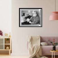 Dr. J. Walter Fewkes, seated at desk, facing left, examining disk showing figure entering maze - 2, Vintage Print