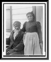 Historic Framed Print, [Elderly African American couple posed outside of building, near Hampton Institute, Hampton, Va.],  17-7/8" x 21-7/8"