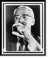 Dr. Albert Sabin, head-and-shoulders portrait, facing slightly left, examining a vial that held a live-virus vaccine for polio, Historic Print