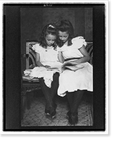 Two girls wearing white dresses and dark stockings reading a book - 2, Historic Print