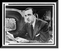 Historic Framed Print, [Walter Cronkite, half-length portrait, facing left, seated at desk with notes in hand and television monitor showing his image for The Morning Show"",  17-7/8" x 21-7/8"