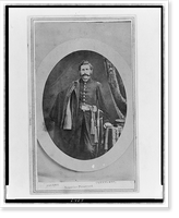 Unidentified Union officer, three-quarter length portrait, standing with coat over right shoulder, left hand resting on table, facing front, Antique Print