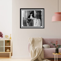 Alice Paul, half-length portrait, seated, facing slightly right, sewing suffrage flag, Vintage Poster