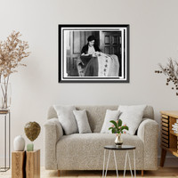 Alice Paul, half-length portrait, seated, facing slightly right, sewing suffrage flag, Vintage Poster