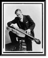John Jacob Niles, full-length portrait, seated, looking down at his dulcimer Classic, Antique Wall Art