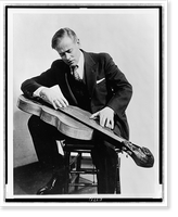 John Jacob Niles, full-length portrait, seated, looking down at his dulcimer Classic, Antique Wall Art