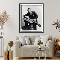 John Jacob Niles, full-length portrait, seated, looking down at his dulcimer Classic, Antique Wall Art