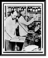 A pharmacist demonstrates the use of a telephone disc prescription recorder as G.W. Wallace fills a prescription Classic, Antique Print