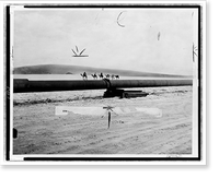 Historic Framed Print, [Camel caravan making its way across desert next to the trans-Arabian oil pipeline],  17-7/8" x 21-7/8"