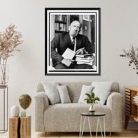 John Steinbeck, three-quarter length portrait, seated, facing front, holding copy of his book Travels with Charley"", Vintage Poster