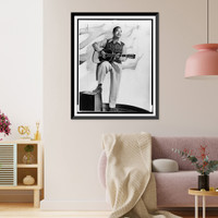 Josh White, full-length portrait, standing, facing right, holding guitar.photo by Albert A. Freeman. Classic, Vintage Poster